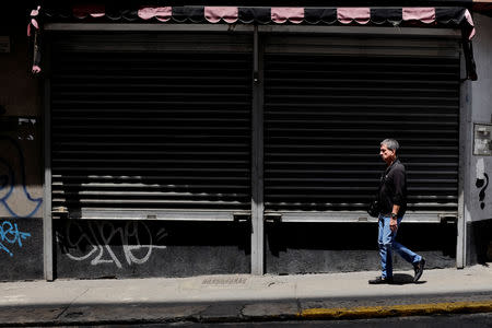 A man walks past closed stores in Caracas, Venezuela September 14, 2018. REUTERS/Marco Bello