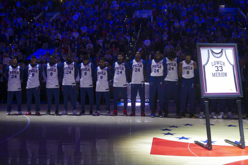 Philadelphia 76ers players stand during a tribute to Kobe Bryant before the team's NBA basketball game against the Golden State Warriors on Tuesday, Jan. 28, 2020, in Philadelphia. Bryant died along with his daughter and seven other people during helicopter crash Sunday. (Steven M. Falk/The Philadelphia Inquirer via AP)