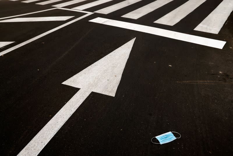 A protective mask is seen on a street in Tomares