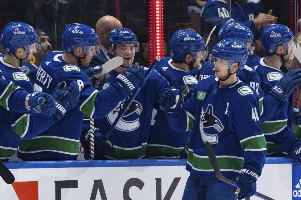Vancouver Canucks' Elias Pettersson (40) is congratulated for a goal against the Winnipeg Jets during the second period of an NHL hockey game Saturday, March 9, 2024, in Vancouver, British Columbia. (Ethan Cairns/The Canadian Press via AP)