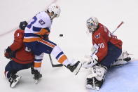 Washington Capitals goaltender Braden Holtby (70) makes a save as New York Islanders left wing Anders Lee (27) looks for the rebound and Capitals defenseman Nick Jensen (3) defends during the first period of an NHL Stanley Cup playoff hockey game in Toronto on Thursday, Aug. 20, 2020. (Nathan Denette/The Canadian Press via AP)