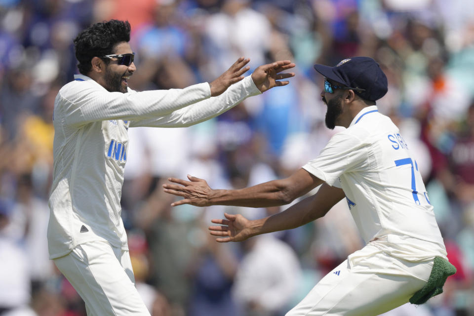 India's Ravindra Jadeja, left celebrates with teammate India's Mohammed Siraj after taking the wicket pf Australia's Cameron Green on the fourth day of the ICC World Test Championship Final between India and Australia at The Oval cricket ground in London, Saturday, June 10, 2023. (AP Photo/Kirsty Wigglesworth)