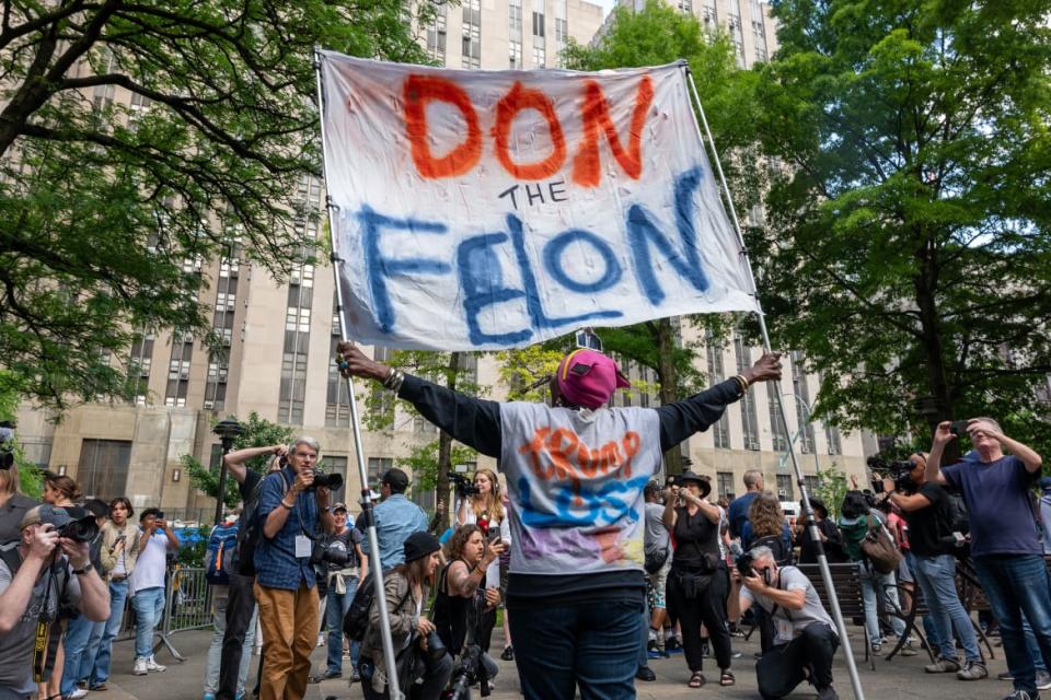 The sign people are holding up reads, "Don the Ferron"