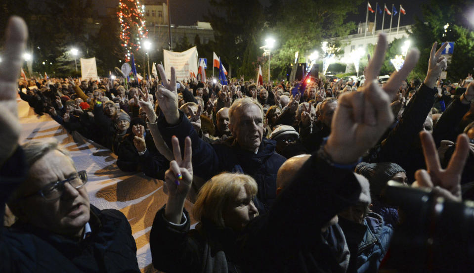 Demonstrators hold a rally to protest against changes to Poland's judiciary planned by the ruling Law and Justice party near the building of parliament in Warsaw, Poland, Wednesday, Dec. 18, 2019. (AP Photo/Czarek Sokolowski)