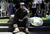 A man looks on as opposing factions gather over the cancelation of conservative commentator Ann Coulter's speech at the University of California, Berkeley, in Berkeley, California, U.S., April 27, 2017. REUTERS/Stephen Lam