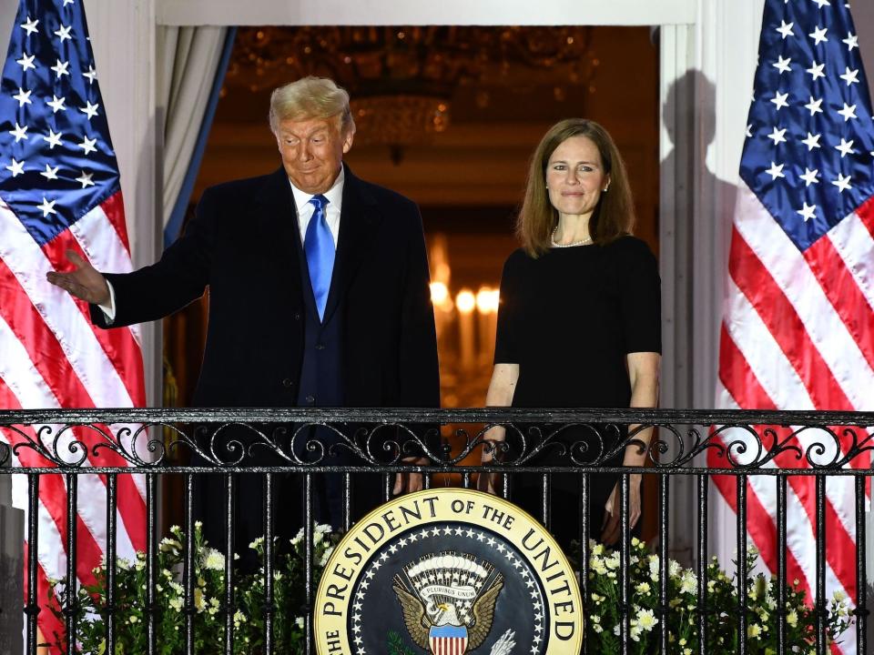 Trump stands with now-Justice Amy Coney Barrett at the White House after she was sworn in on October 26, 2020.