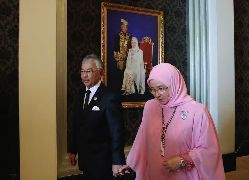 Malaysia's King Al-Sultan Abdullah Sultan Ahmad Shah and Queen Tunku Azizah Aminah Maimunah Iskandariah walk holding hands after an interview, in Kuala Lumpur