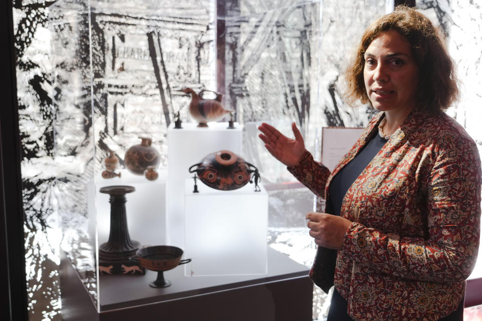 Archaeologist Sara Neri talks about the 750 archaeological finds from clandestine excavations on Italian territory on display during a press conference in Rome, Wednesday, May 31, 2023. The set of artifacts, which can be dated overall between the eighth century BC. and the medieval period, and whose value is estimated at 12 million euros, was in possession of an English company in liquidation, Symes Ltd, attributable to Robin Symes, an important trafficker of cultural assets, and was repatriated from London on 19 May. (AP Photo/Domenico Stinellis)