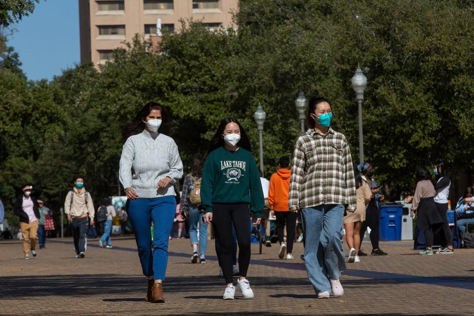 January 2022 file photo from left, of Richa Tiwary, Vivian Nguyen and Xin Fang walking on campus at The University of Texas at Austin on Tuesday.
