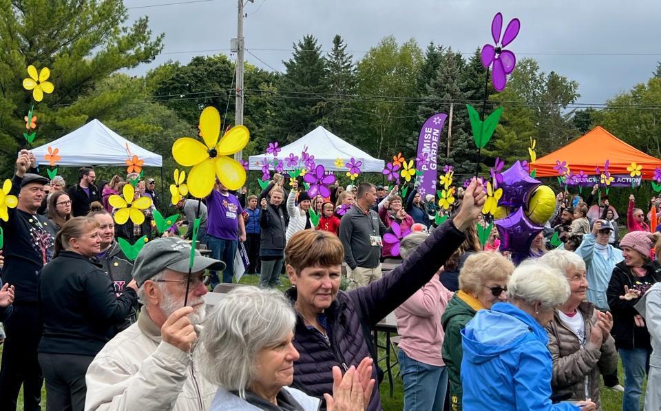 Promise Garden flowers are raised as more than 400 walkers from across the area participate in Walk to End Alzheimer’s in Sheboygan County at Evergreen Park Sept. 24.