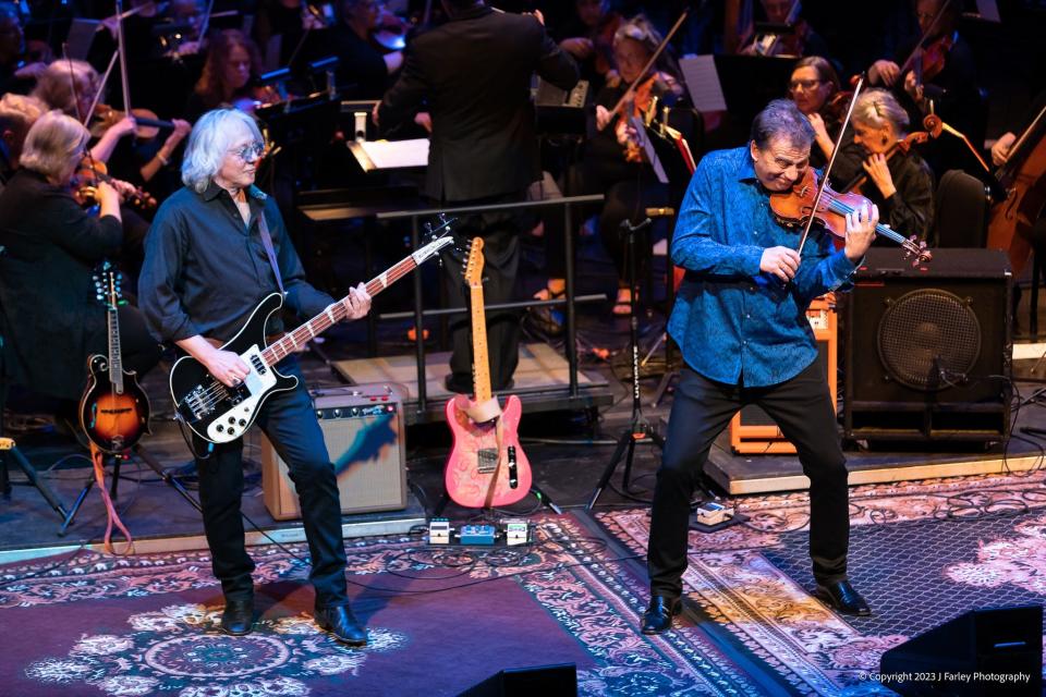 The touring show “R.E.M. Explored” features R.E.M. bassist Mike Mills (left) and Grammy-nominated violinist Robert McDuffie performing with orchestras.