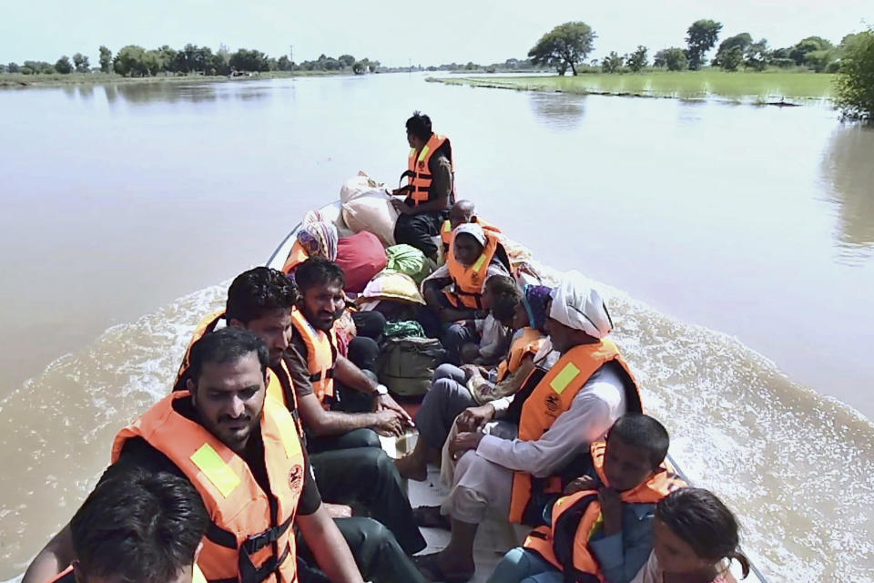 In this photo released by Rescue 1122 Emergency Department, rescue workers use a boat to evacuate villagers from a flooded area of Bahawalnagar district in Pakistan's Punjab province, Wednesday, Aug. 23, 2023. Rescuers have evacuated more than 100,000 people from flood-hit areas of Pakistan's eastern Punjab province in the past three weeks, officials said Wednesday. (Rescue 1122 Emergency Department vis AP)