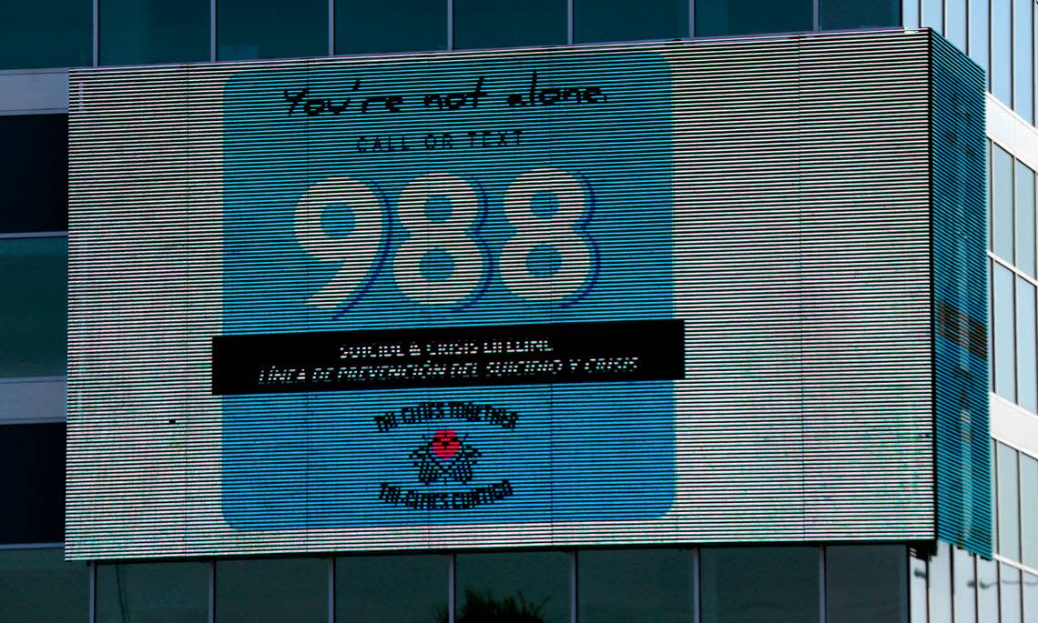 The electronic message board on the HAPO building on the corner of West Clearwater Avenue and Columbia Center Boulevard in Kennewick displays a message for the Tri-Cities Together suicide and crisis lifeline telephone and text number: 988.