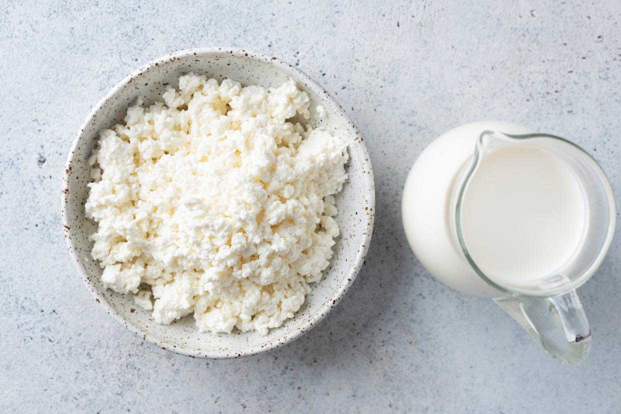 Cottage cheese, farmers cheese and jar of cow's milk. Dairy products, top view