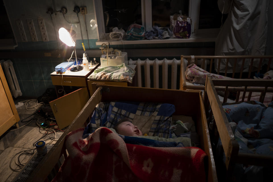 Orphaned children sleep inside cribs at the children's regional hospital maternity ward in Kherson, southern Ukraine, Tuesday, Nov. 22, 2022. Throughout the war in Ukraine, Russian authorities have been accused of deporting Ukrainian children to Russia or Russian-held territories to raise them as their own. At least 1,000 children were seized from schools and orphanages in the Kherson region during Russia’s eight-month occupation of the area, their whereabouts still unknown. (AP Photo/Bernat Armangue)