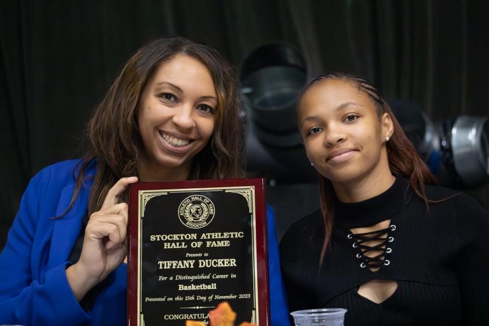 Tiffany Ducker (left) and her daughter Jordan pose for a photo after Tiffany was inducted into the Stockton Athletic Hall of Fame at the Stockton Memorial Civic on Wednesday Nov. 15, 2023