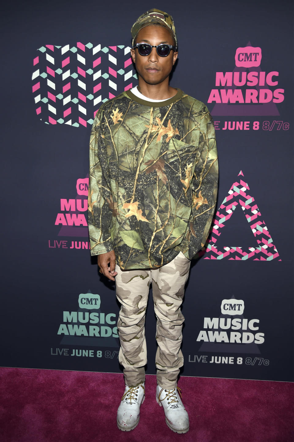 Pharrell Williams wearing a camouflage ensemble