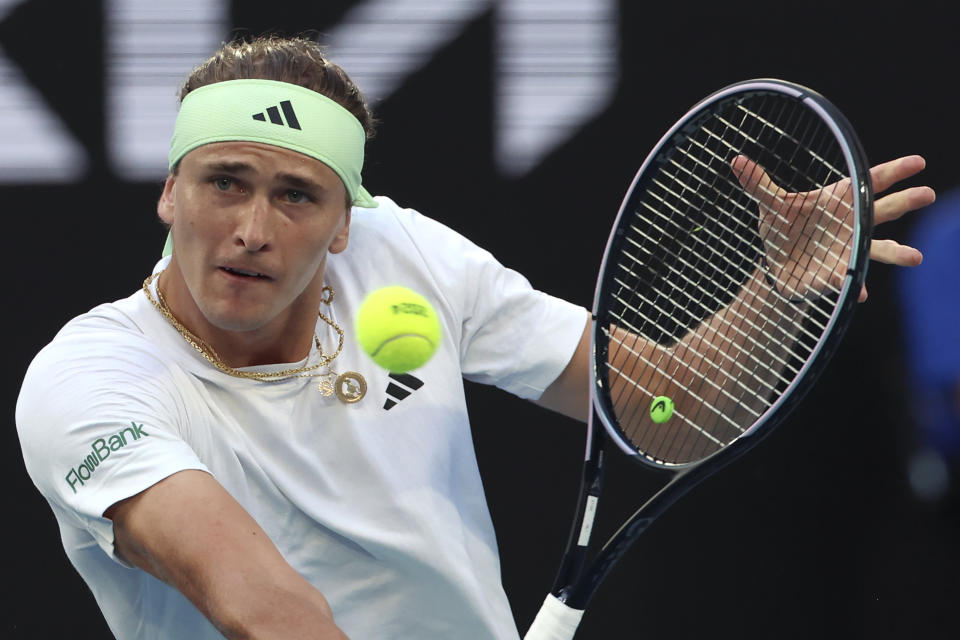 Alexander Zverev of Germany plays a backhand return to compatriot Dominik Koepfer during their first round match at the Australian Open tennis championships at Melbourne Park, Melbourne, Australia, Tuesday, Jan. 16, 2024. (AP Photo/Asanka Brendon Ratnayake)