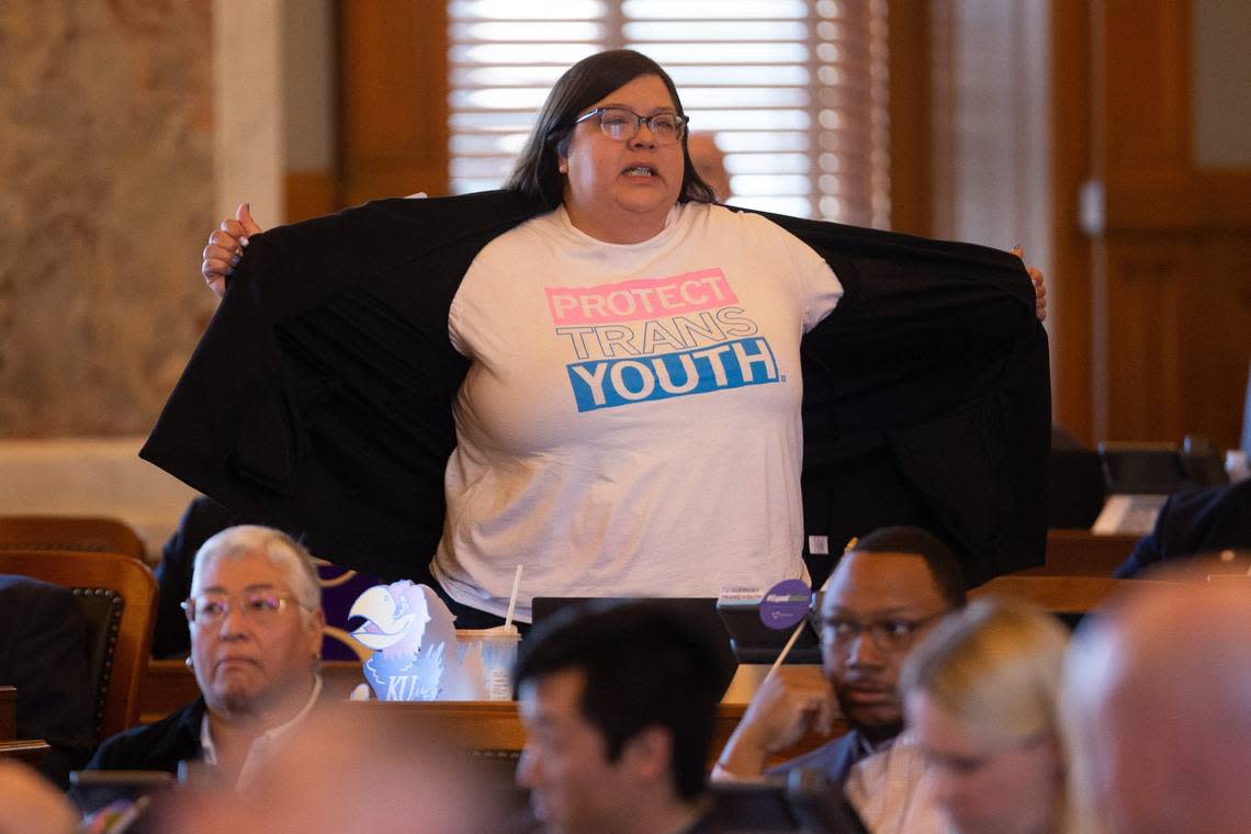 Rep. Heather Meyer, D-Overland Park, shows her “protect trans youth” t-shirt to legislative members following a vote to override Gov. Laura Kelly’s veto on a bill banning transgender athletes from women’s sports. Meyer has a trans child.