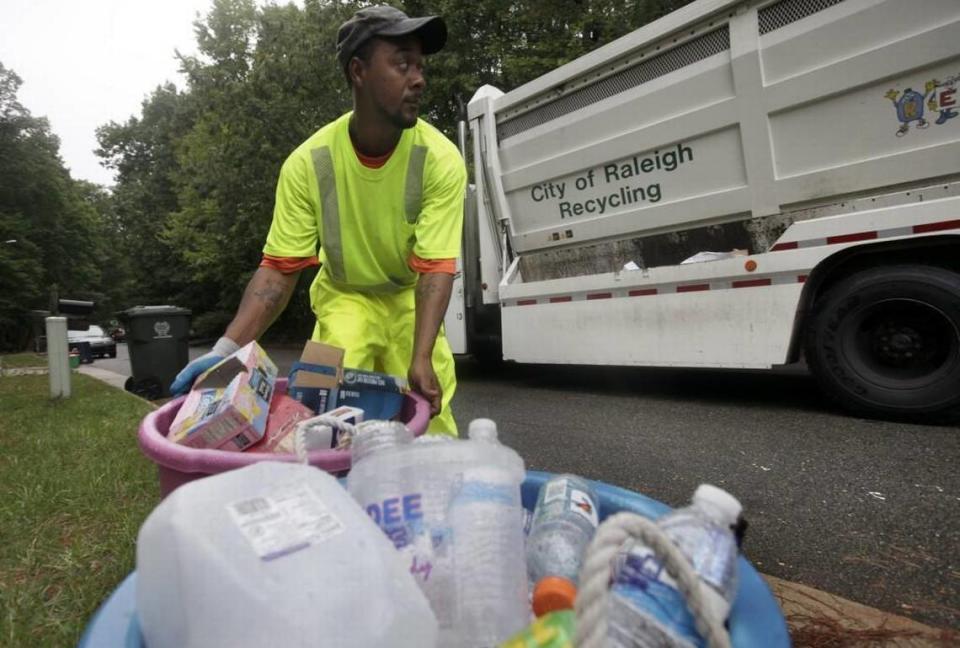 In this file photo from 2009, a worker with Raleigh’s solid waste services department collects recycling in North Raleigh.