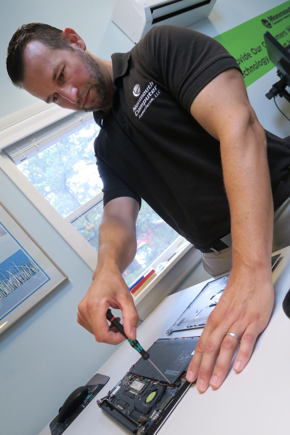 Monmouth Computer Associates owner Dan Carroll works on a laptop at the Brick Township business Thursday, July 7, 2022. 