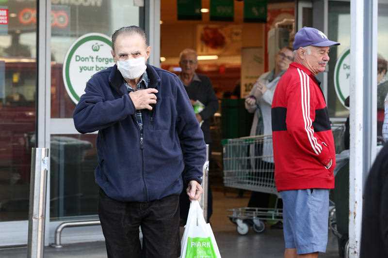 A man in a face mask leaves Woolworths at Marrickville.