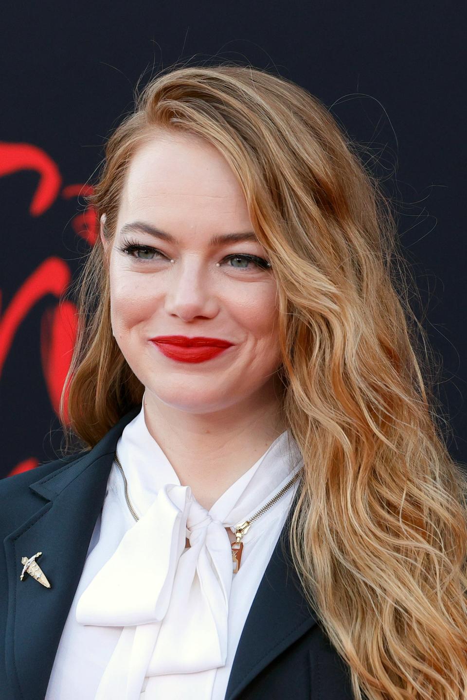 Emma Stone wearing a black blazer and white top at an event