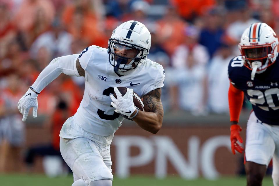 Penn State wide receiver Parker Washington (3) carries the ball against Auburn during the second half of an NCAA college football game, Saturday, Sept. 17, 2022, in Auburn, Ala. (AP Photo/Butch Dill)