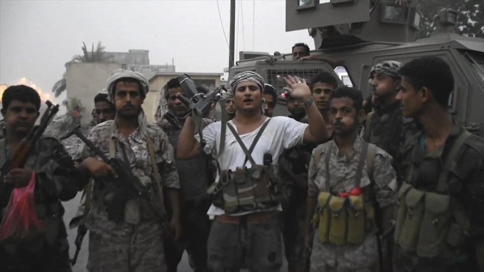 In this Friday Aug. 9, 2019 frame grab from video, Southern Transitional Council separatist fighters line up before storming the presidential palace in the southern port city of Aden, Yemen. The separatists backed by the United Arab Emirates began withdrawing Sunday from positions they seized from the internationally-recognized government in Aden. Both the southern separatists and the government forces are ostensibly allies in the Saudi-led military coalition that’s been battling the Houthi rebels in northern Yemen since 2015, but the four days of fighting in Aden have exposed a major rift in the alliance. (AP Photo)