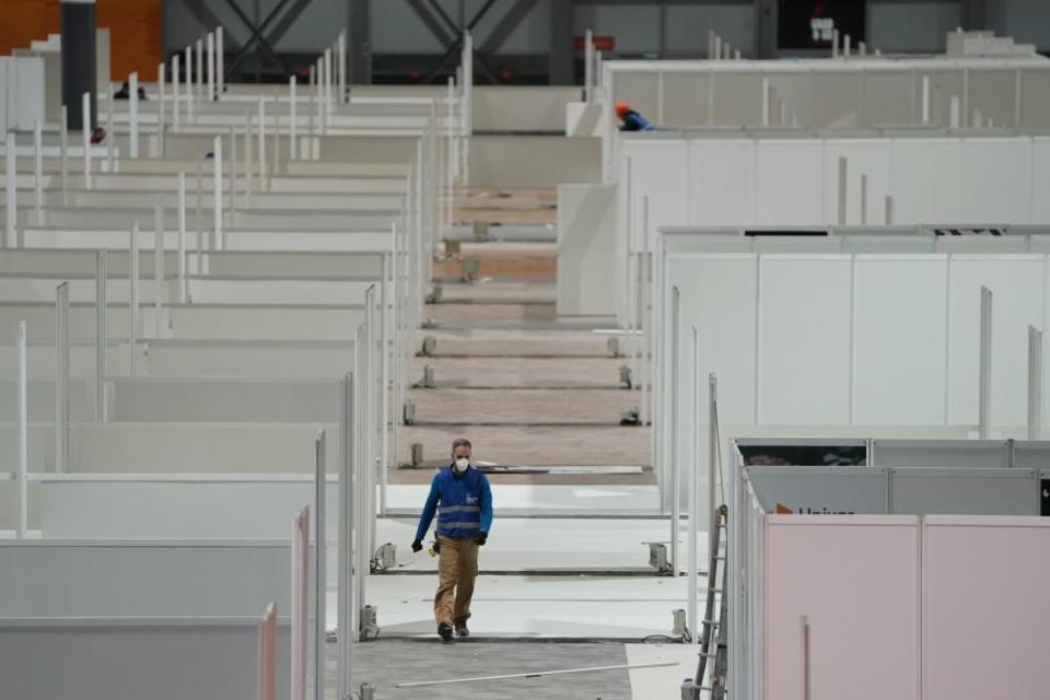 Workers install a field hospital for coronavirus patients in Madrid, Spain, on 21 March, in a handout photo.