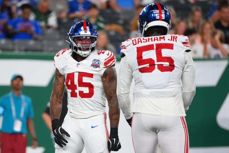 Aug 24, 2024; East Rutherford, New Jersey, USA; New York Giants linebacker Tomon Fox (45) reacts to his sack with teammate linebacker Boogie Basham (55) against the New York Jets during the first half at MetLife Stadium. Mandatory Credit: Rich Barnes-USA TODAY Sports