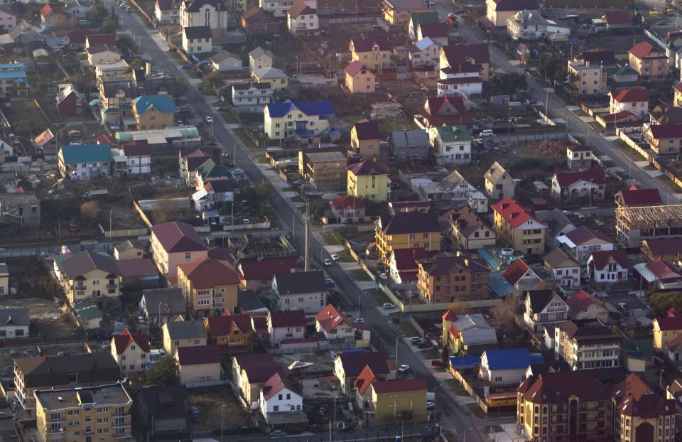 An aerial view from a helicopter shows residential houses in the Adler district of the Black Sea resort city of Sochi, December 23, 2013. Sochi will host the 2014 Winter Olympic Games in February. Picture taken December 23, 2013. REUTERS/Maxim Shemetov (RUSSIA - Tags: CITYSCAPE BUSINESS SPORT OLYMPICS)