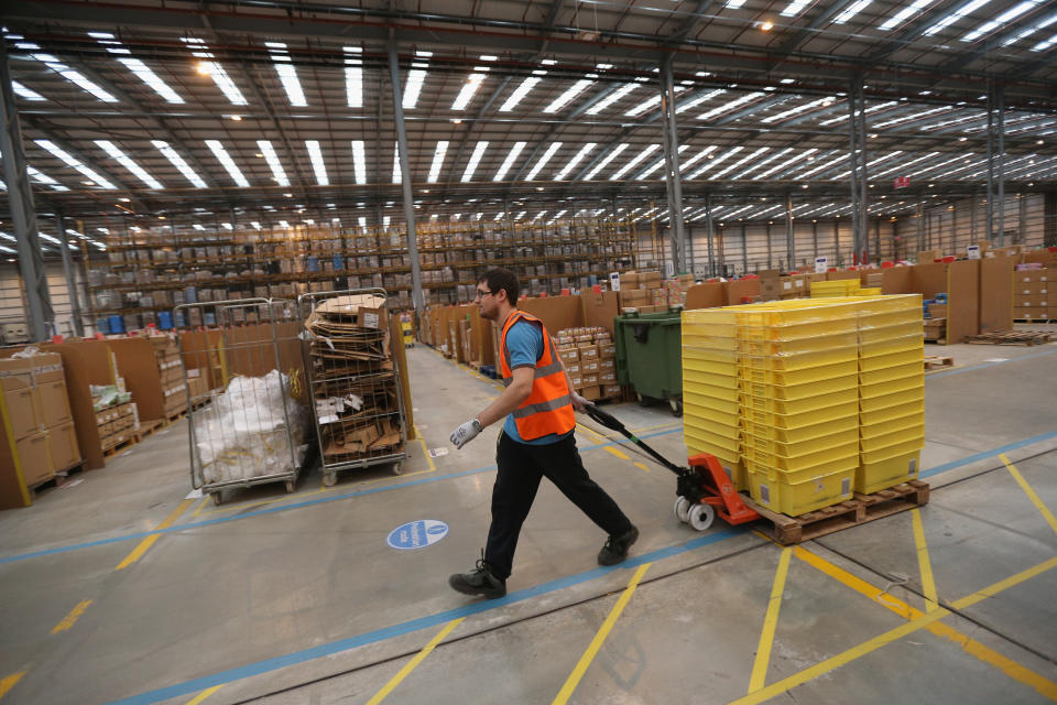 PETERBOROUGH, ENGLAND - NOVEMBER 28:  Employees select and dispatch items in the huge Amazon 'fulfilment centre' warehouse on November 28, 2013 in Peterborough, England. The online retailer is preparing for 'Cyber Monday', as it predicts the busiest day for online shopping in the UK will fall on Monday December 2nd this year. On Cyber Monday in 2012 amazon.co.uk recorded over 3.5 million individual items ordered, which equates to 41 items purchased per second. The Peterborough fulfilment centre is 500,000 sq ft, equivalent to approximately seven football pitches in floor area. Amazon are due to employ more than 1,000 seasonal staff to cope with increased demand in the run up to Christmas.  (Photo by Oli Scarff/Getty Images)