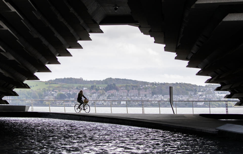 A cyclist passes the closed V&A Museum in Dundee as the UK continues in lockdown to help curb the spread of the coronavirus.