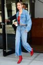 <p>In an oversized denim jacket, matching denim pants, red tube top and red booties while out in NYC. </p>