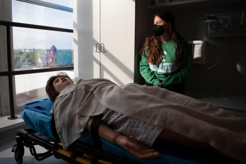 Junior Paige Fox sits for a portrait inside of an ambulance simulation at Battle Creek Central High School on Friday, May 20, 2022.