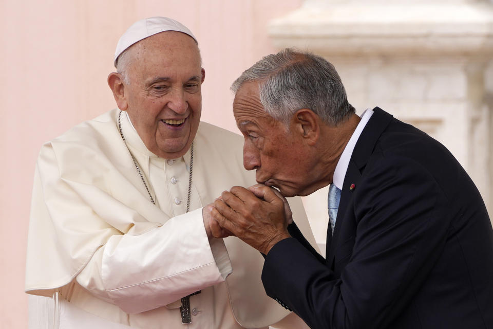 Portuguese President Marcelo Rebelo de Sousa kisses the hand of Pope Francis after a welcome ceremony outside the Belem presidential palace in Lisbon, Wednesday, Aug. 2, 2023. Pope Francis arrived Wednesday in Lisbon to attend the international World Youth Day that is expected to bring hundreds of thousands of young Catholic faithful to Portugal and finishes Aug. 6. (AP Photo/Armando Franca)