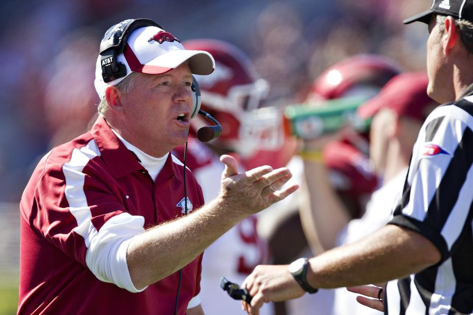 Head Coach Bobby Petrino of the Arkansas Razorbacks talks with a official during a game against the Ole Miss Rebels at Vaught-Hemingway Stadium on October 22, 2011 in Oxford, Mississippi.  The Razorbacks defeated the Rebels 29 to 24.    