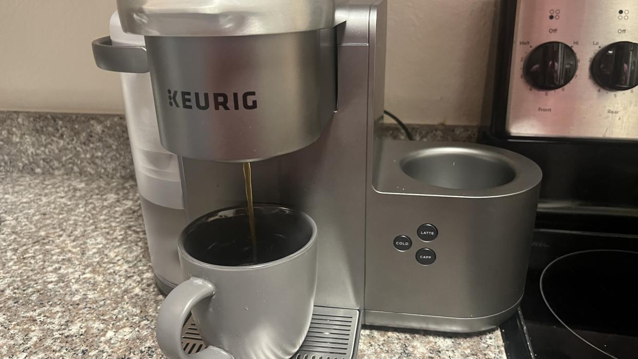  Keurig K-Café Special Edition pouring a coffee with k-cup on countertop. 