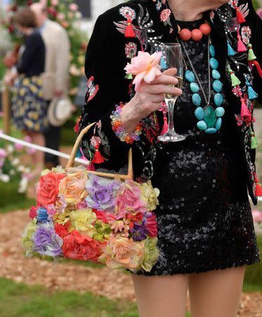 A woman carries a floral design handbag at the RHS Chelsea Flower Show in London, Britain, May 21, 2018. REUTERS/Toby Melville