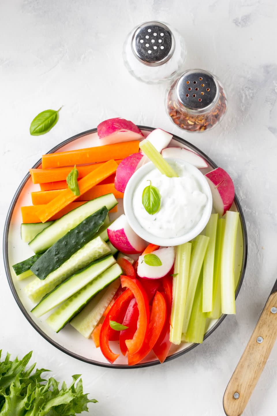 mediterranean diet vegetable sticks of cucumber pepper carrots celery and radishes with yogurt dip