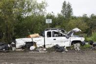 A discarded pickup truck rests on the outskirts of the village landfill, Friday, Aug. 18, 2023, in Akiachak, Alaska. (AP Photo/Tom Brenner)