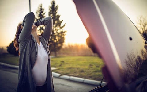 Woman driving car engine breakdown - Credit: E+/South_agency