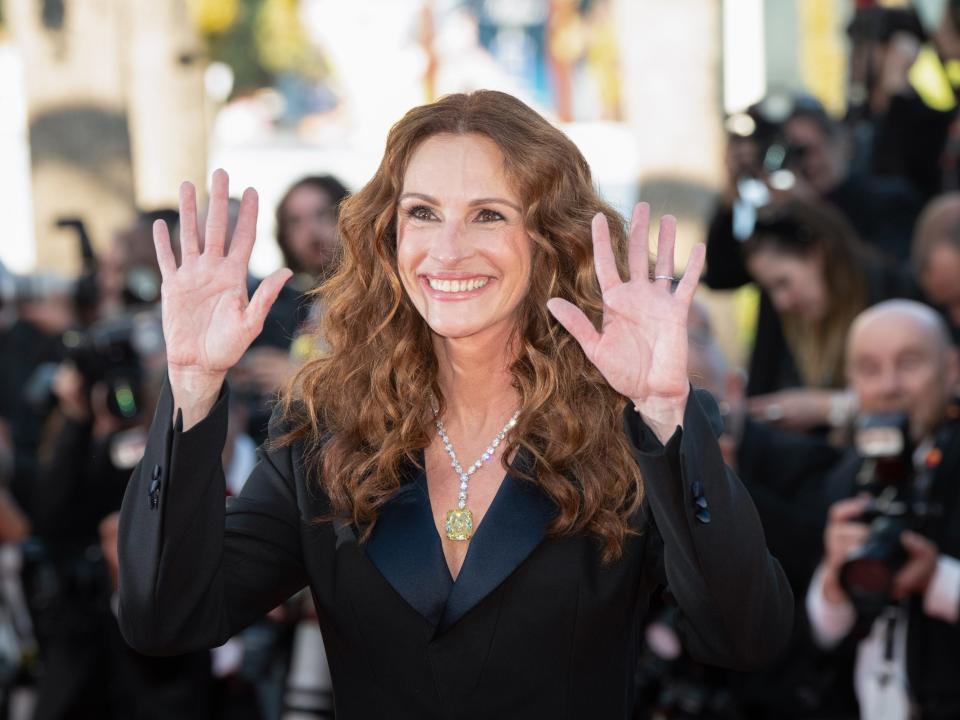 Julia Roberts with her hands up while being photographed at the 2022 Cannes Film Festival