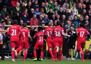 Liverpool's Raheem Sterling (C) embraces team manager Brendan Rodgers after scoring a goal during their English Premier League match against Norwich City, at Carrow Road in Norwich, on April 20, 2014