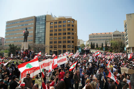 Protesters wave Lebanese national flags during a demonstration against proposed tax increase, in front of the government palace in Beirut, Lebanon March 19, 2017. REUTERS/Alia Haju