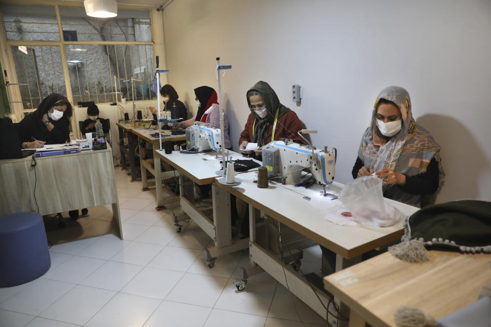 Women sew protective face masks at a workshop of Bavar charity in Tehran, Iran, Monday, Nov. 23, 2020. As the coronavirus pandemic ravages Iran, a women’s group hopes to empower its members by helping them make and sell face masks. (AP Photo/Vahid Salemi)