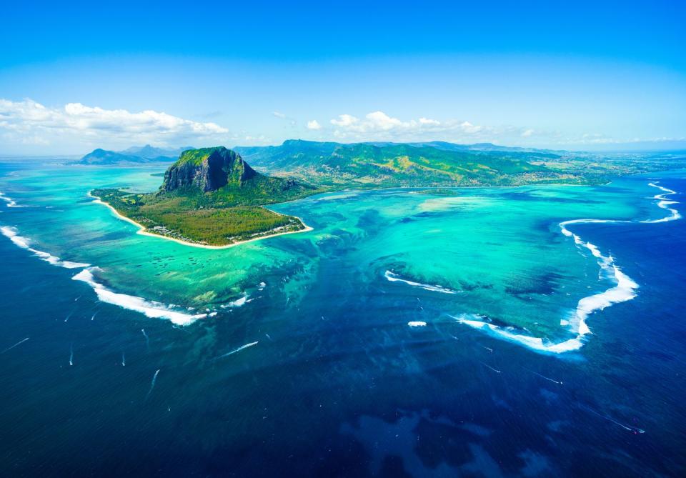 aerial view of mauritius island panorama and famous le morne brabant mountain, beautiful blue lagoon and underwater waterfall