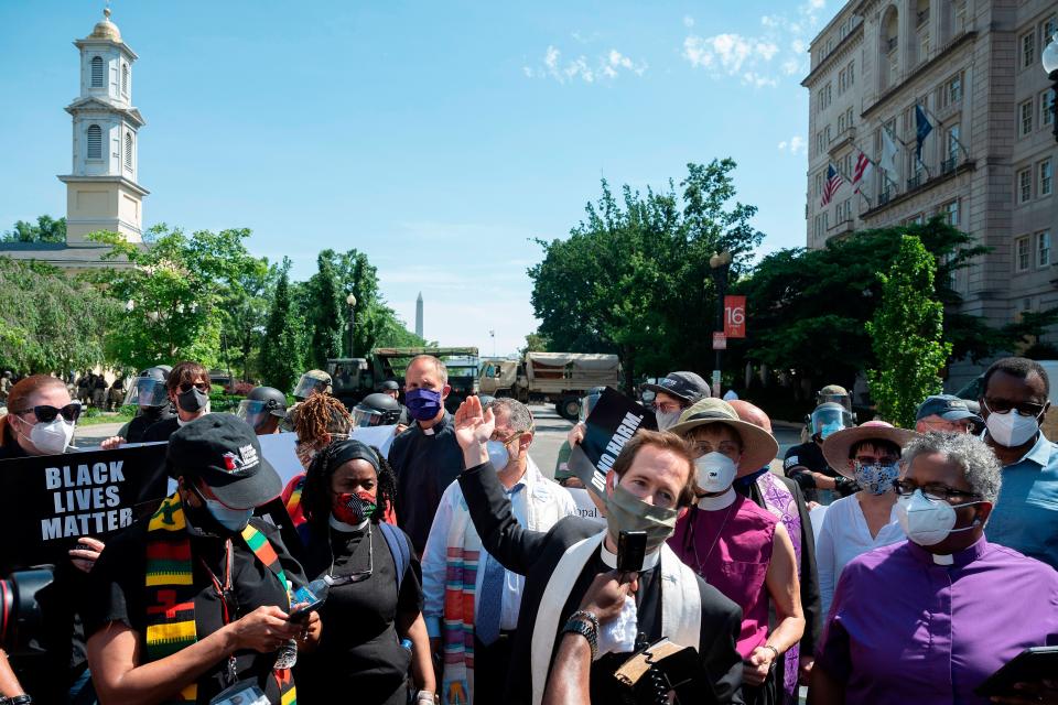 The Rev. Robert Fisher, center, of St. John's Church speaks alongside other clergy during a truncated prayer vigil Wednesday in Washington, D.C.