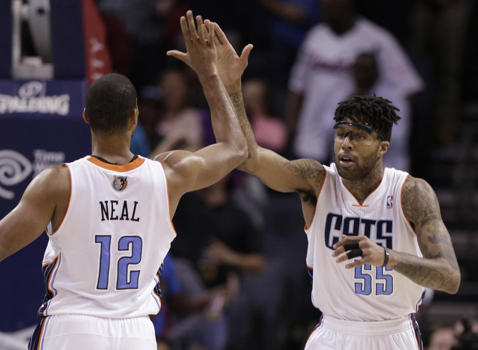 Charlotte Bobcats' Chris Douglas-Roberts (55) is congratulated by Gary Neal (12) after making a basket against the Washington Wizards during the second half of an NBA basketball game in Charlotte, N.C., Monday, March 31, 2014. The Bobcats won 100-94. (AP Photo/Chuck Burton)